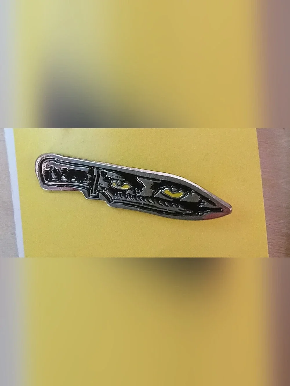 Black Blade Metal Lapel Pin with Yellow Eye Accents